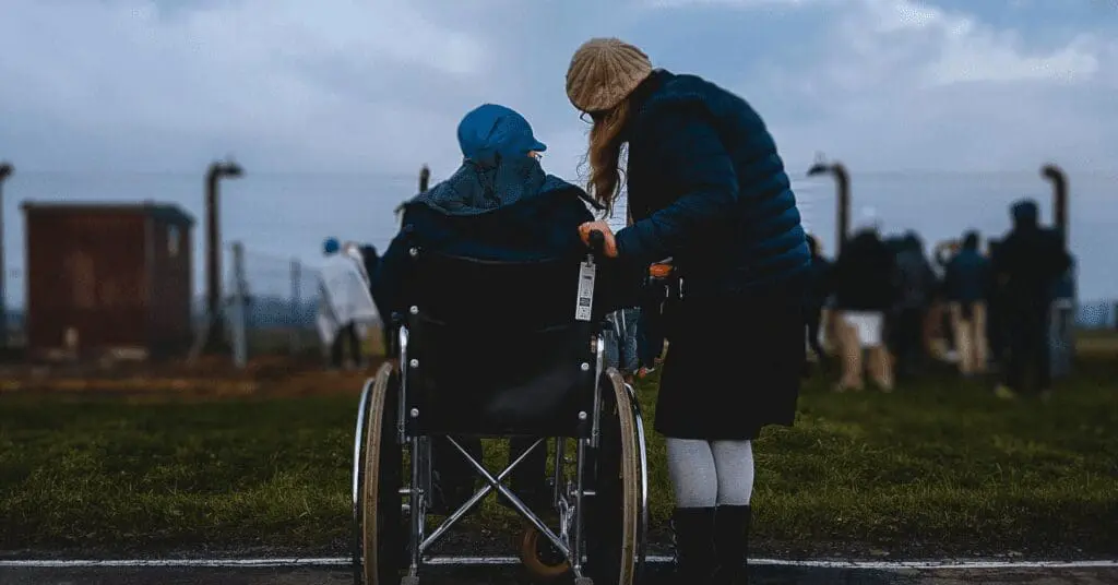 Student in wheelchair beside another student img