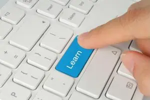 A keyboard with various multimedia and social media icons on its keys, symbolizing digital marketing and internet connectivity. A female hand is typing on the keyboard, illustrating concepts such as online business, email communication, and secure technology. The network of interconnected icons represents ideas related to content creation, commentary, and social media services in the digital age.