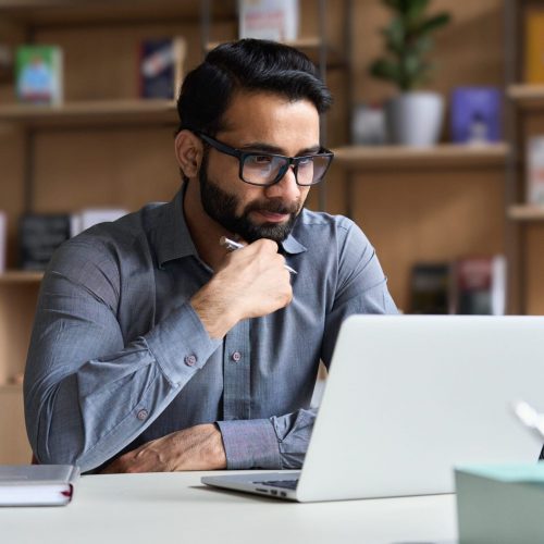 YoungSeriousIndianProfessionalBusinessManFocusedEthnicMaleStudent
